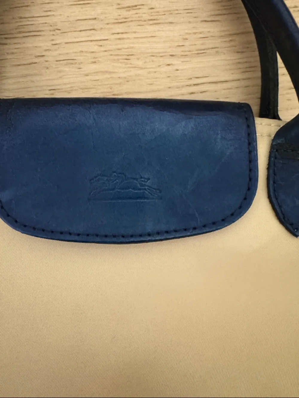 Longchamp Small Le Pliage Cream Tote with Navy Trim. Top zip with snap flap.